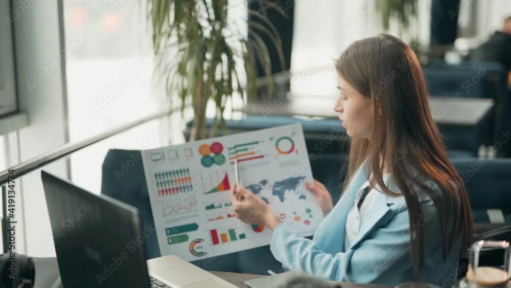 Charismatic beautiful girl gives a presentation on infographics