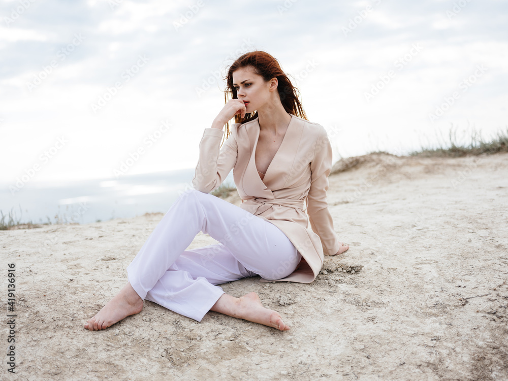 Woman in light clothes outdoors clouds blue sky sand Woman in light clothes outdoors clouds blue sky sand