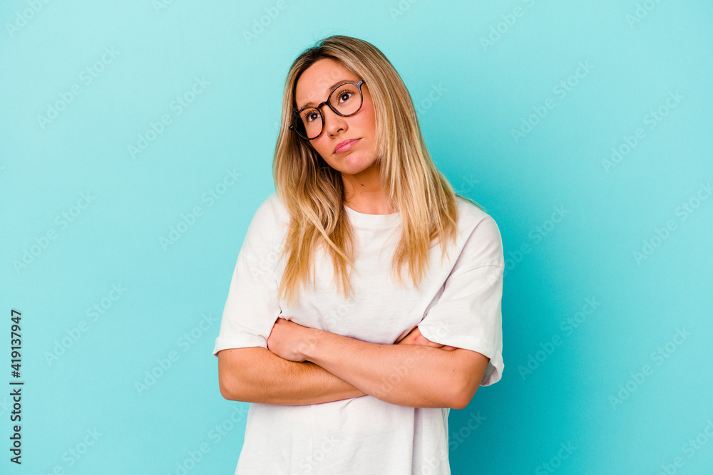 Young mixed race woman isolated on blue background tired of a repetitive task. Young mixed race woman isolated on blue background tired of a repetitive task.