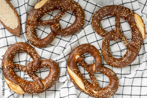 Obraz na płótnie German pretzel. Pretzels with sesame seeds on the light gray kitchen table w salonie