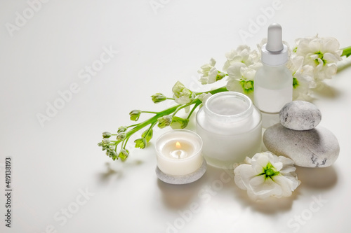 Composition with symbolic objects for spa salon. Stone therapy attributes for cosmetic procedures. Conceptual image, rocks and flowers representing balance. Close up, copy space, top view, background.