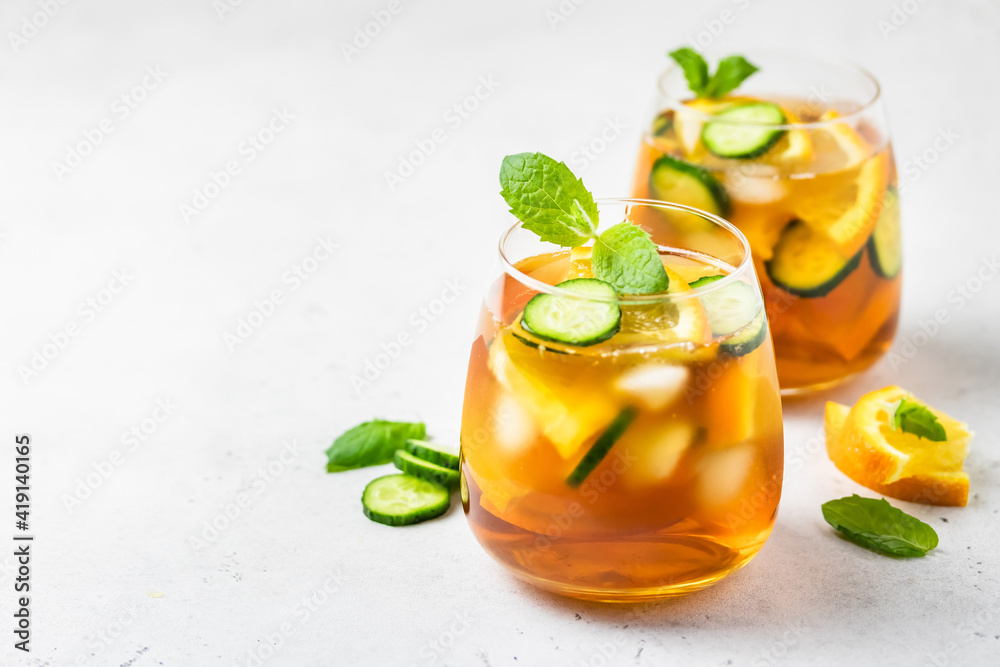 Cold brew cucumber orange iced tea in glasses. Space for text. Cold brew cucumber orange iced tea in glasses. Space for text.