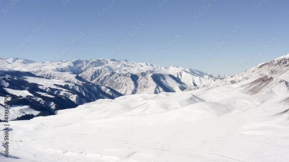 Drone video cinematic natural landscape in winter. mountains with slopes and peaks on which grow forests covered with snow .