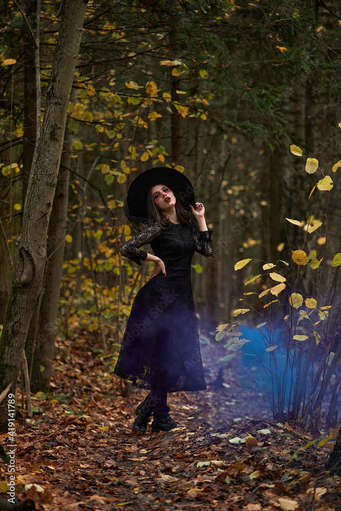 Fototapeta premium Fashion photo of woman with with creative make up in a forest. Fantasy