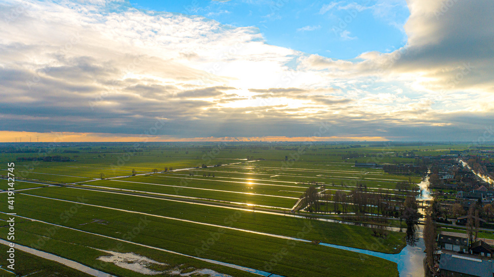 Fototapeta premium Green fields with sun breaktrough