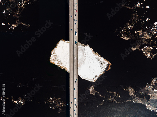 Aerial top-down view of Salu bridge in Riga during winter. The cars drive over the bridge photo