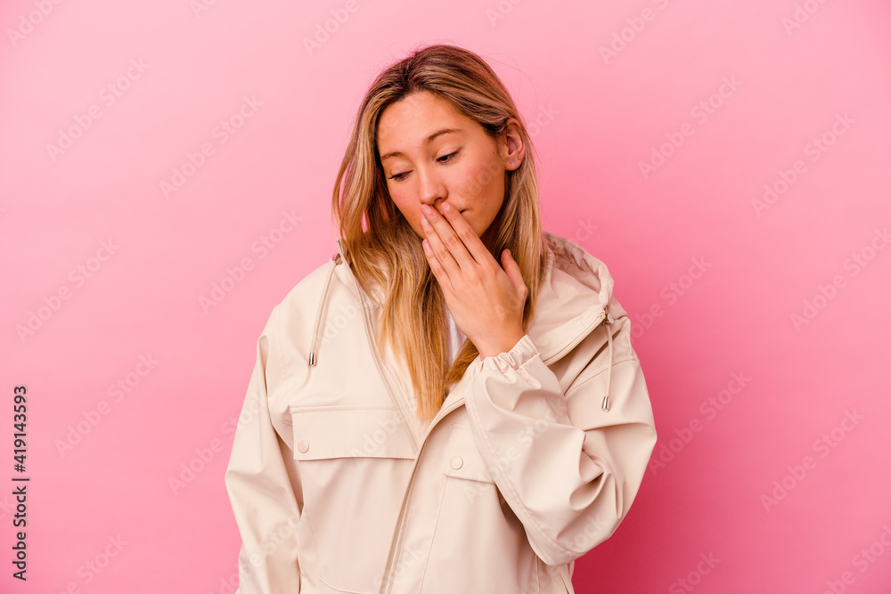 Young mixed race woman isolated on pink background yawning showing a tired gesture covering mouth with hand. Young mixed race woman isolated on pink background yawning showing a tired gesture covering mouth with hand.