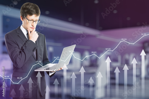 Forex trade analytics concept with businessman looking at laptop and digital arrows and growing diagram