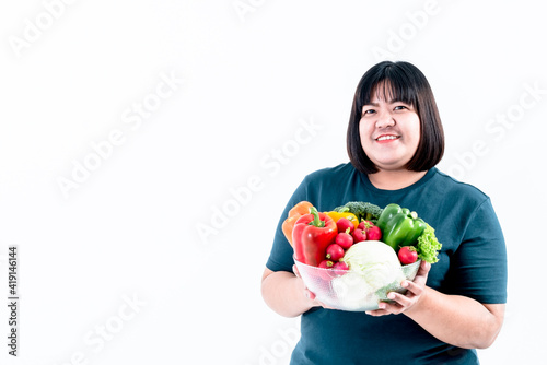 Portrait images of Asian attractive fat woman holding glass bowl contains fruit and fresh vegetables On white background, to woman with health food and weight loss concept.