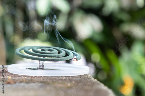 Fotografie Closeup on traditional mosquito repellent coil emit smoke to repel mosquito outd