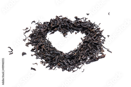 dry black tea heap isolated on white background. indian dried tea leaf cut out. heart shape