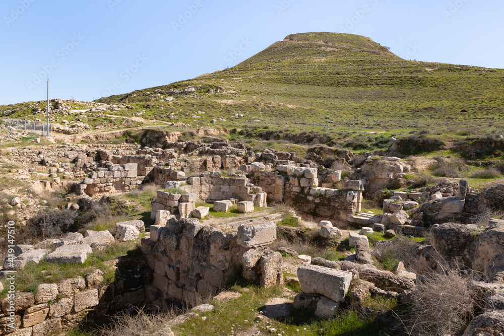 The ruins  of outer part of the palace of King Herod, against the background of the filled artificial hill in which they are located the palace of King Herod - Herodion,in the Judean Desert, in Israel