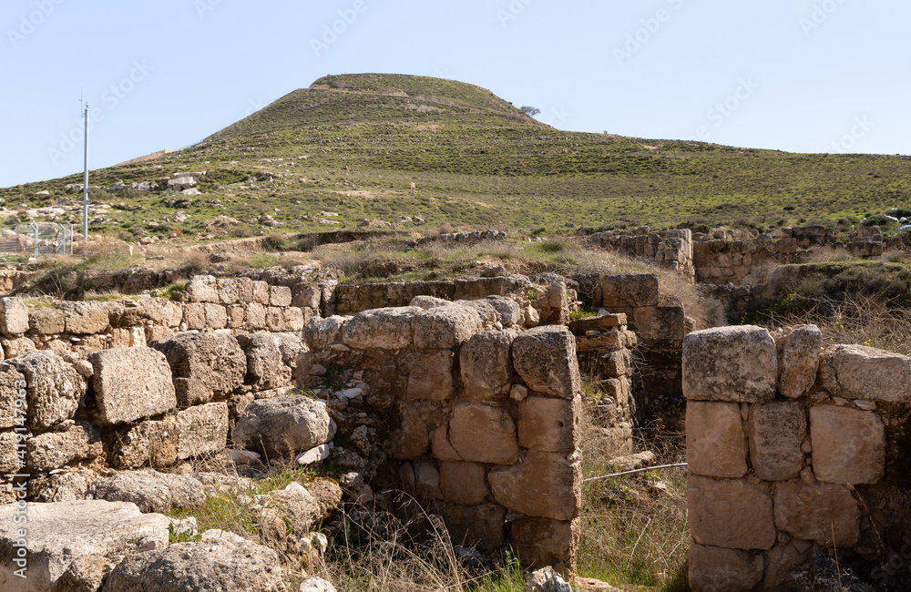 The ruins  of outer part of the palace of King Herod, against the background of the filled artificial hill in which they are located the palace of King Herod - Herodion,in the Judean Desert, in Israel