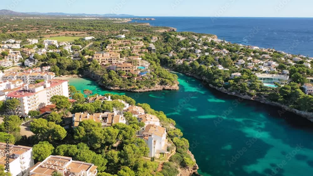 Mallorca, Spain: Aerial view of summer resort town Cala d'Or on Mallorca (Majorca), coast of island and clear waters of Mediterranean Sea - landscape panorama of Balearic Islands from above, Europe