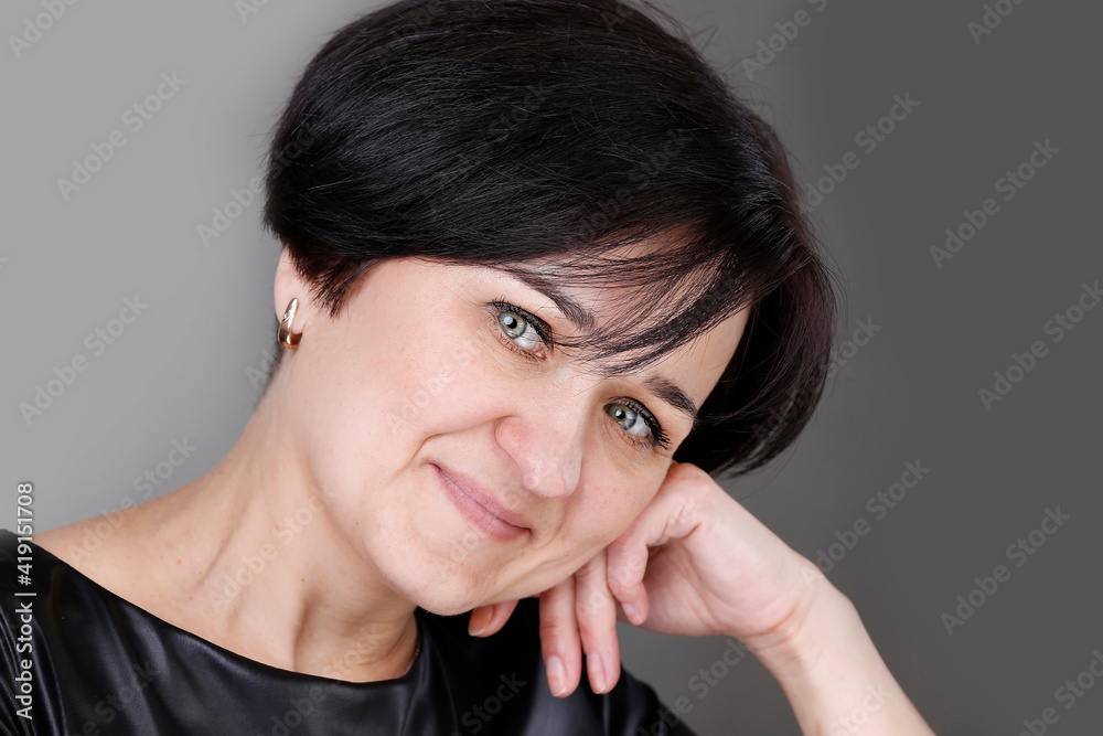 Portrait of a beautiful middle-aged woman. European style blue eyed brunette Portrait of a beautiful middle-aged woman. European style blue eyed brunette