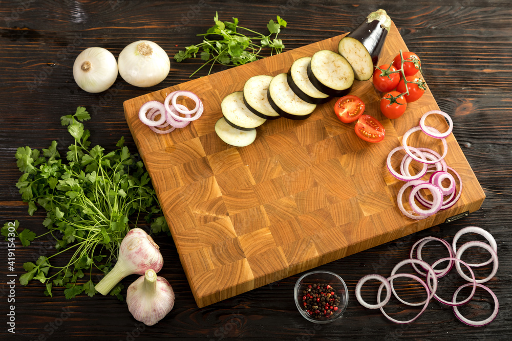 Fresh vegetables, herbs and spices on a cutting board