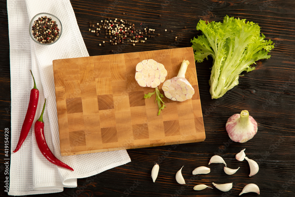 Fresh vegetables, herbs and spices on a cutting board