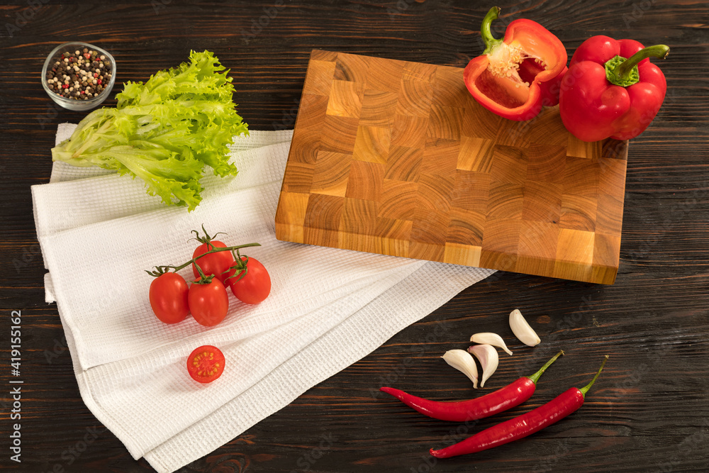 Fresh vegetables, herbs and spices on a cutting board