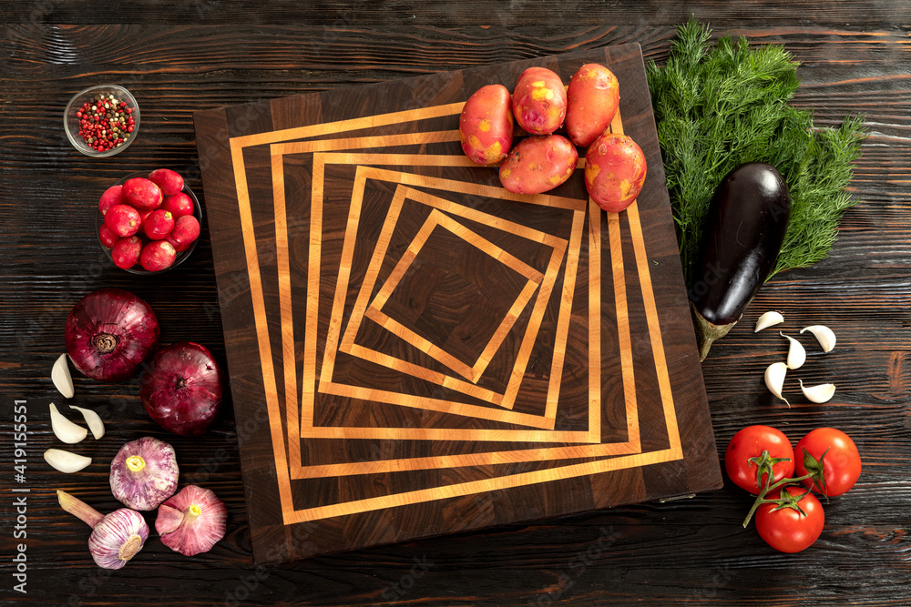 Fresh vegetables, herbs and spices on a cutting board