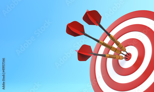 Three darts hitting a red target on the center on blue background with copy space. 3d render illustration photo