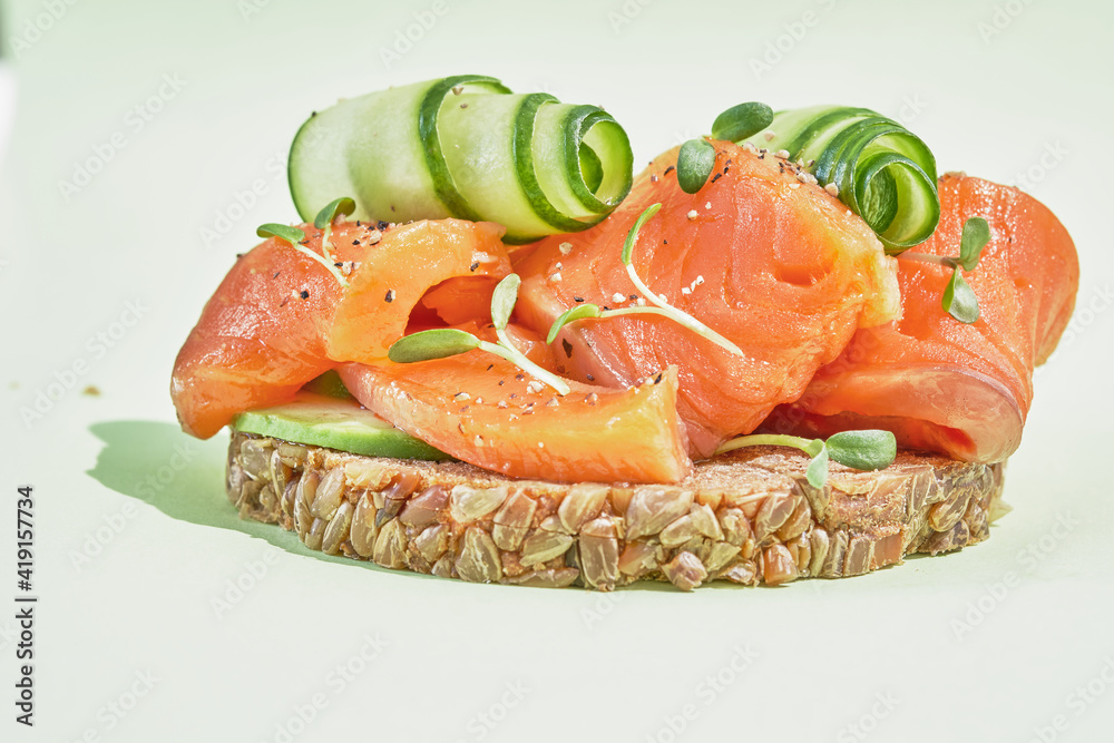 open sanwich with dark rye bread, avocado, smoked salmon, cucumber open sanwich with dark rye bread, avocado, smoked salmon, cucumber