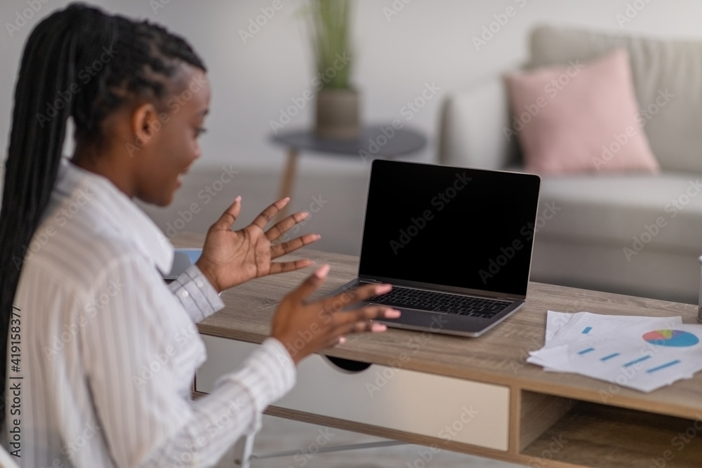 African american lady having online conference from home, using laptop African american lady having online conference from home, using laptop