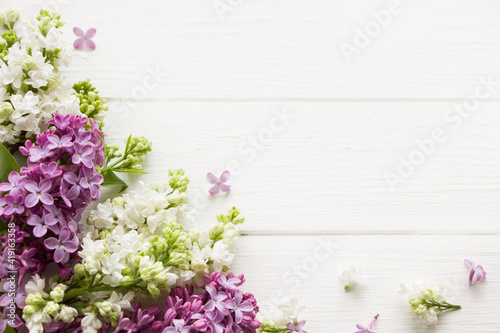 Lilac blooming branches on white wooden board. Spring template . Spring background with empty space for Mother's day, women's day, 8 march, birthday, easter, wedding invitation