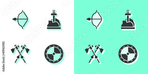 Set Round wooden shield, Medieval bow and arrow, Crossed medieval axes and Sword in the stone icon. Vector.
