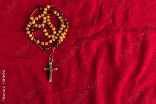 Rosary beads on red background. photo