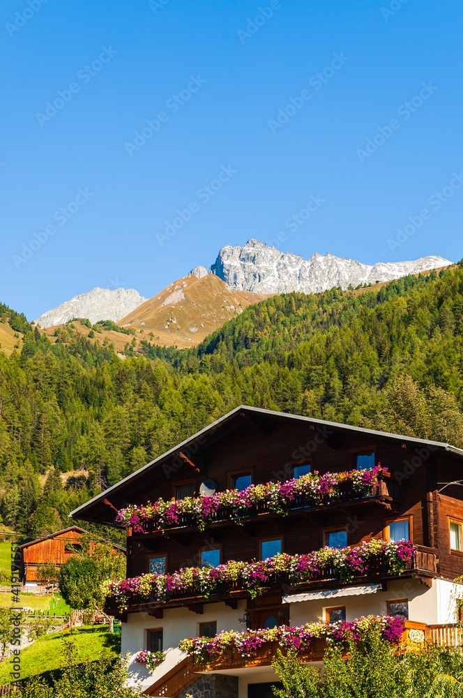 Typical house in Osttirol in front of mountain, Austria