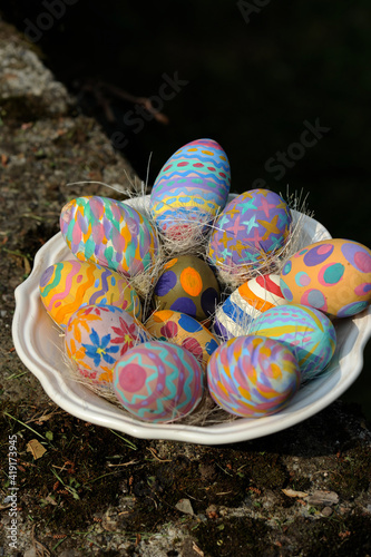 Group of hand painted Easter eggs in a ceramic bowl
