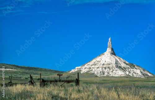 Chimney Rock with old farm equipment in Nebraska photo