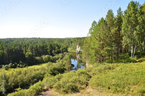 Beautiful nature green trees and a river in the distance. Olenyi Ruchy is a natural park in the Sverdlovsk Region on the territory of the Nizhneserginsky Municipal District