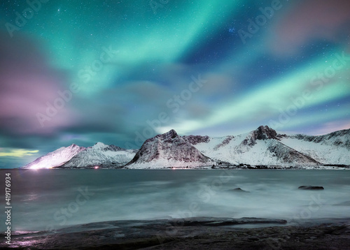 Aurora Borealis. Stars and northern light. Mountains and ocean. Night landscape. Long exposure shot. Senja island, Norway. Nature image © biletskiyevgeniy.com