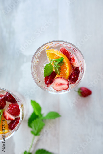 Summer cocktail with strawberry  orange and mint in glass
