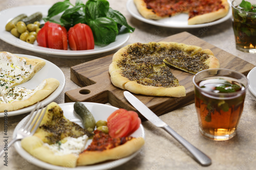 manakeesh, lebantine pizza, topping with zaatar(thyme), labneh(strained yogurt) and groud beef