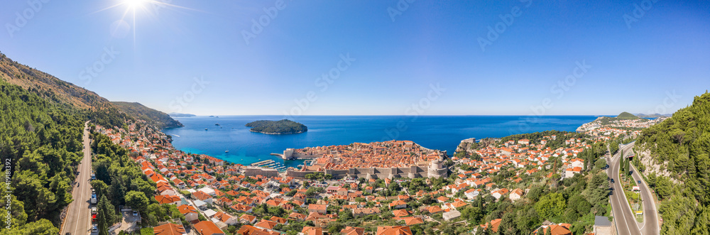 Aerial panorama drone shot of Dubrovnik old town by Adriatic sea with view of Lokrum Island in Croatia summer morning