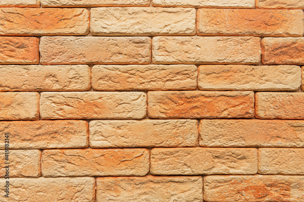 Fototapeta premium bright, orange brick wall background, top view