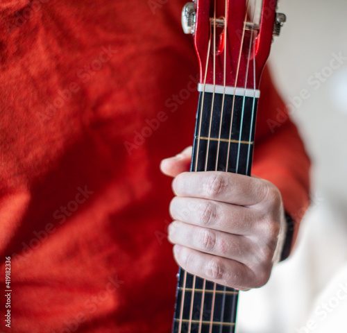 Close-up of a guitar player or a person learning to play the guitar.