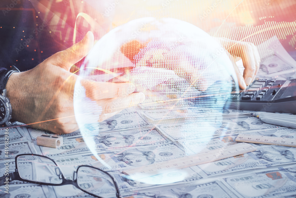 Double exposure of man's hands holding and using a phone and international business theme drawing. Double exposure of man's hands holding and using a phone and international business theme drawing.