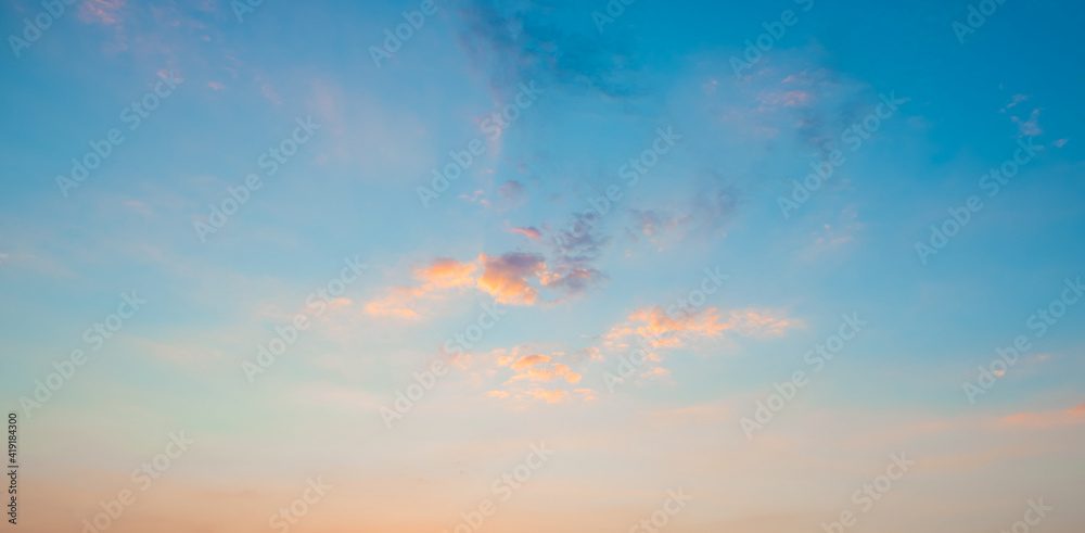 Sunrise clear blue sky with glowing pink clouds at sunset.Blue orange cloudscape