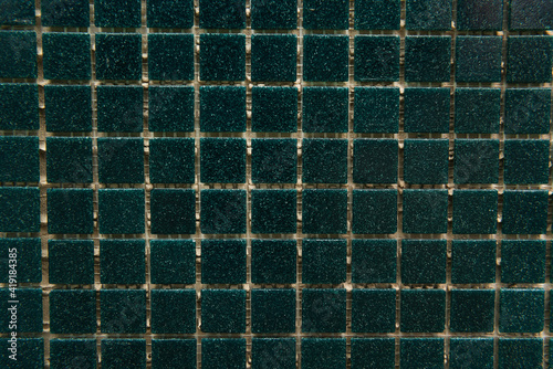 background of dark green  small tiles  top view