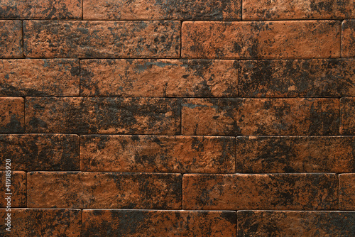 background of wall from bricks in brown and black gradient, top view
