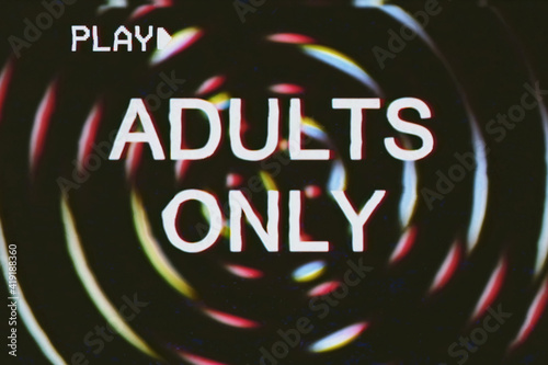 VHS retro fake shot: the text Adults only over a set of circles; grindhouse low-budget b-movie style.
