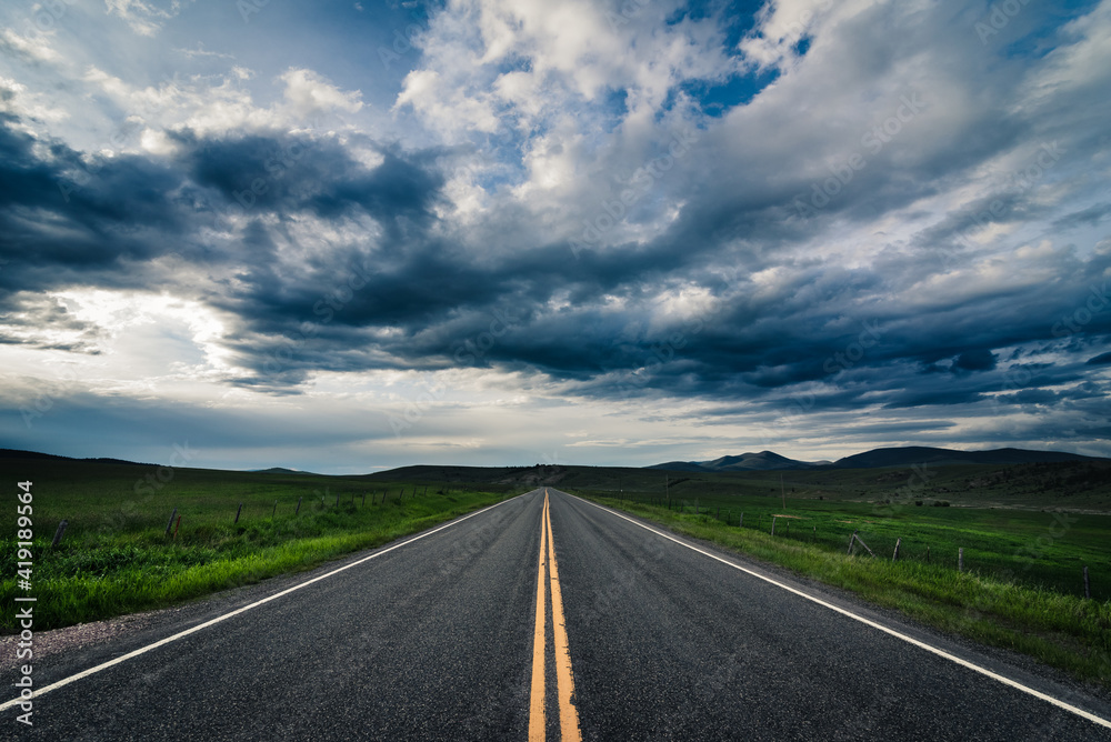 Road heading towards the horizon on a cloudy day. Road heading towards the horizon on a cloudy day.