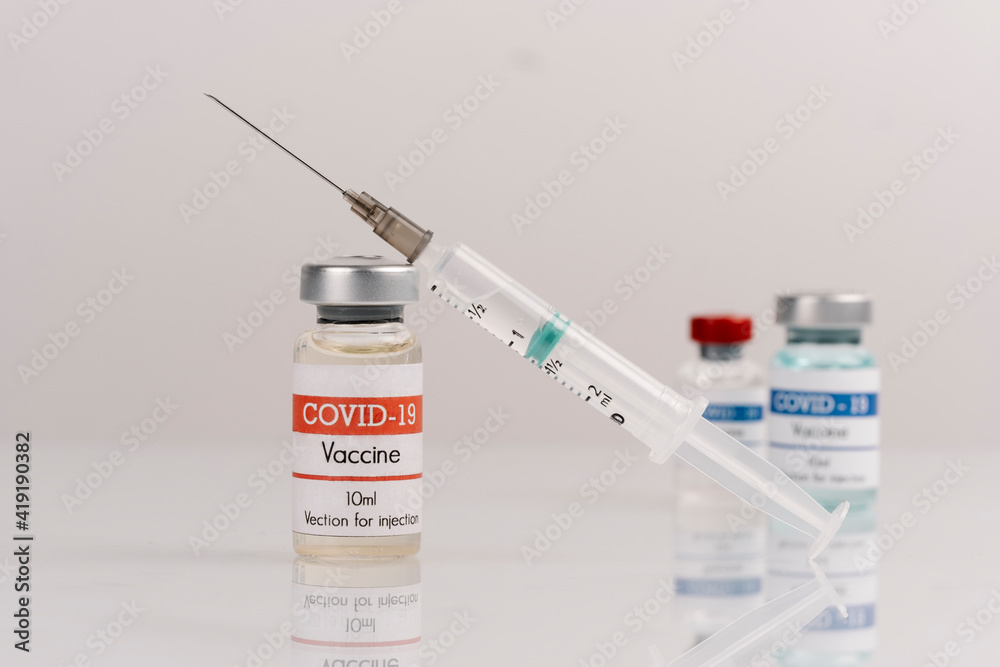 vaccine covid-19 vaccine vials with syringe, on a white background vaccine covid-19 vaccine vials with syringe, on a white background