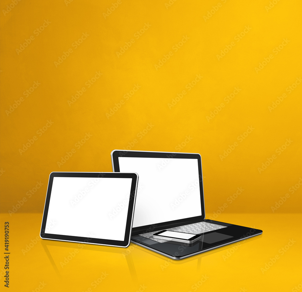 Laptop, mobile phone and digital tablet pc on yellow office desk Laptop, mobile phone and digital tablet pc on yellow office desk