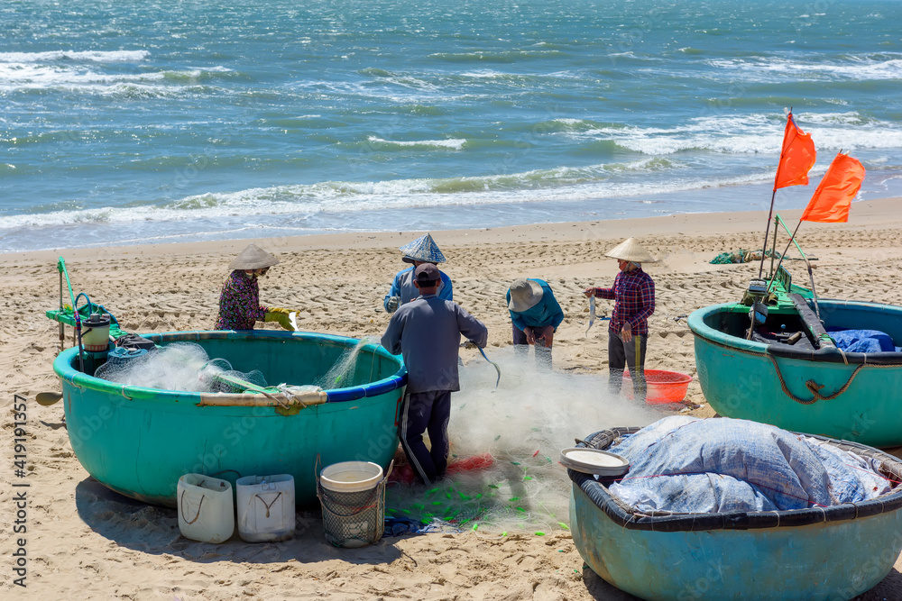 Φωτογραφία The fishermen collecting fish from nets on the beach in Phuoc Hai, Baria- Vungtau province, Vietnam