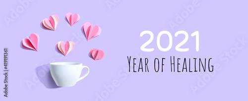 2021 Year of Healing message with a coffee cup and paper hearts - flat lay