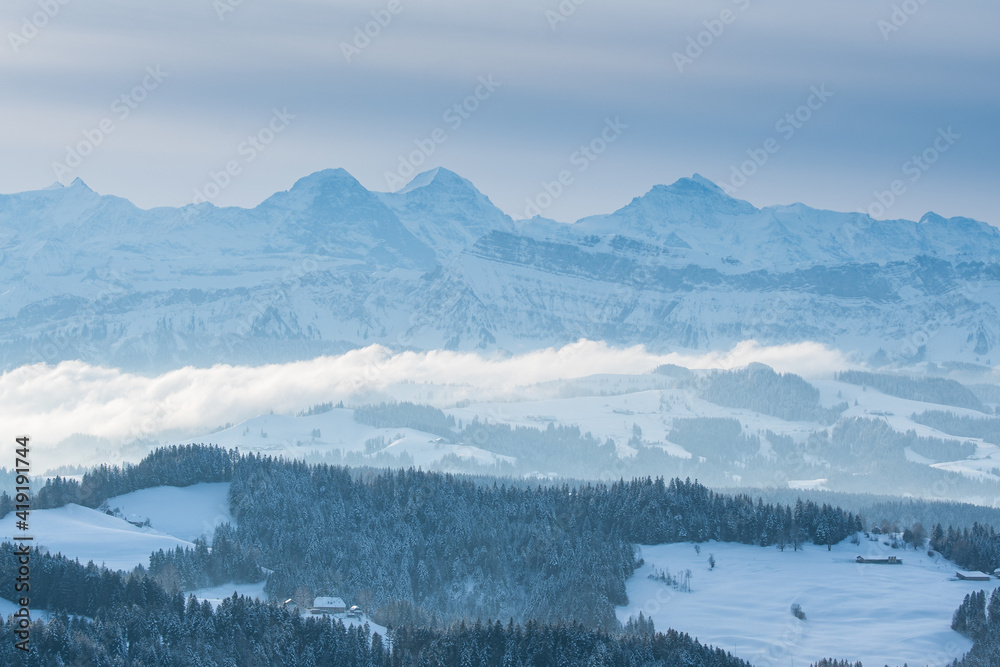 Eiger Mönch and Jungfrau and the landscape of Emmental in winter